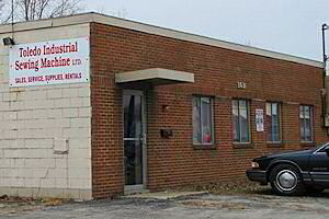Front and sign side of Toledo Industrial Sewing Machines building. Industrial sewing machines